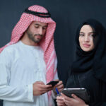 pngtree-young-muslim-business-couple-using-technology-devices-religious-islam-fashionable-photo-image_43224450